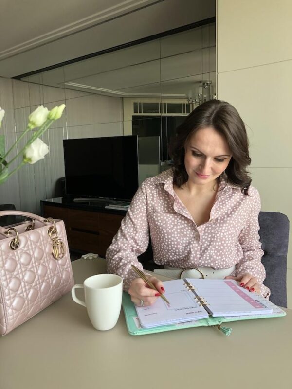 Woman reviewing her weekly planner to understand her energy pattern