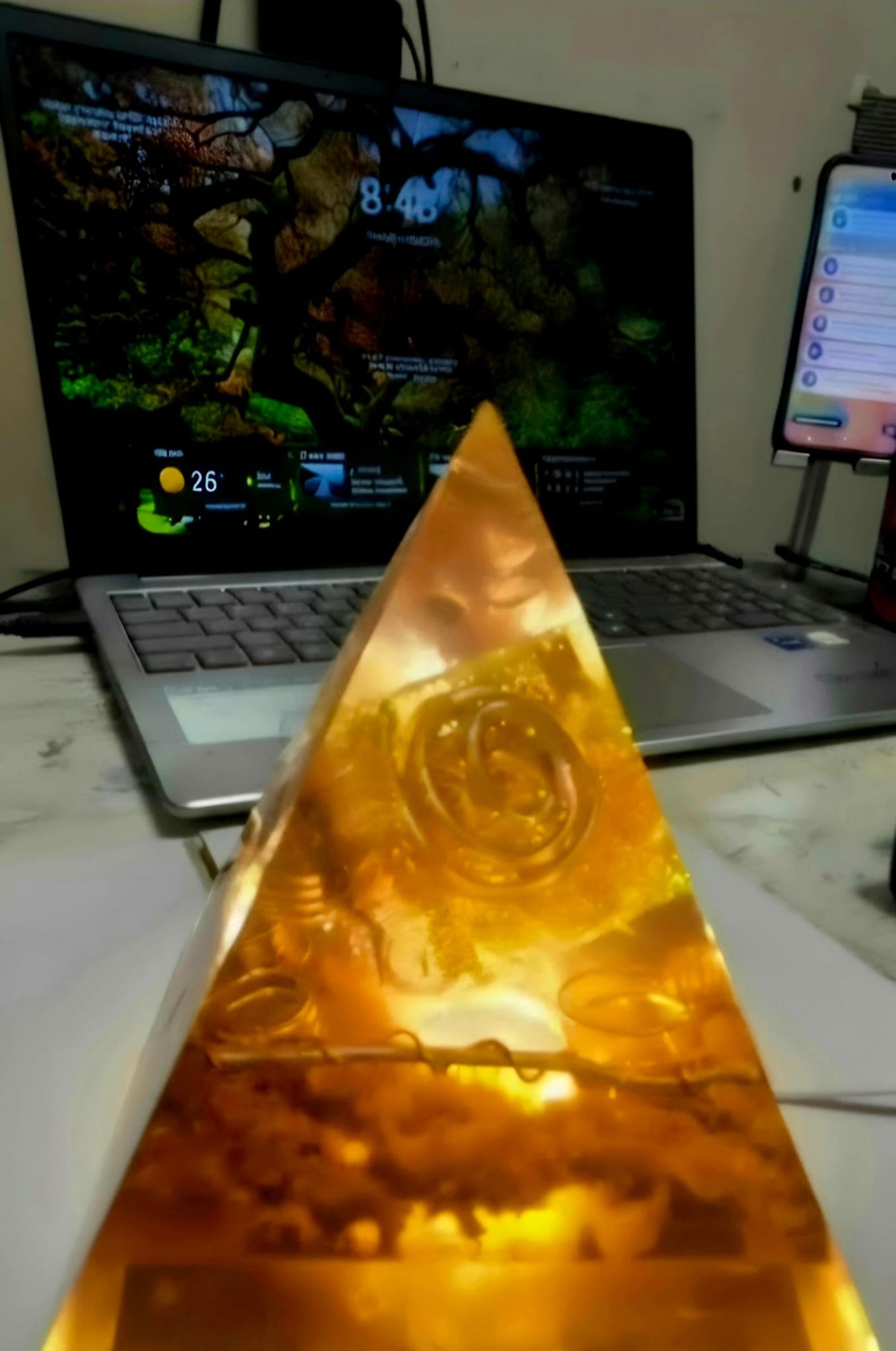 Sacred Light Orgonite Golden Amber Activation Pyramid illuminated with warm amber light