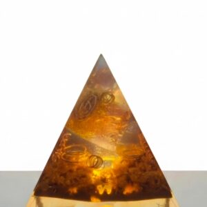 Sacred Light Orgonite Golden Amber Activation Pyramid illuminated with warm amber light