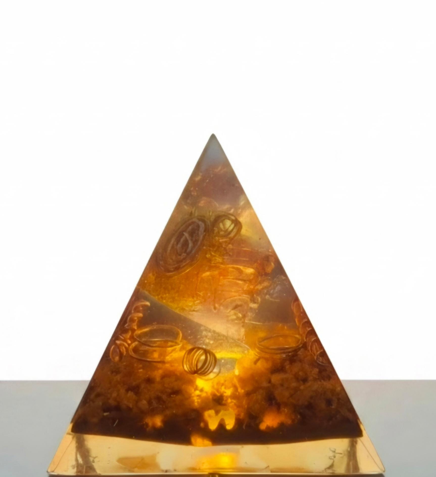 Sacred Light Orgonite Golden Amber Activation Pyramid illuminated with warm amber light