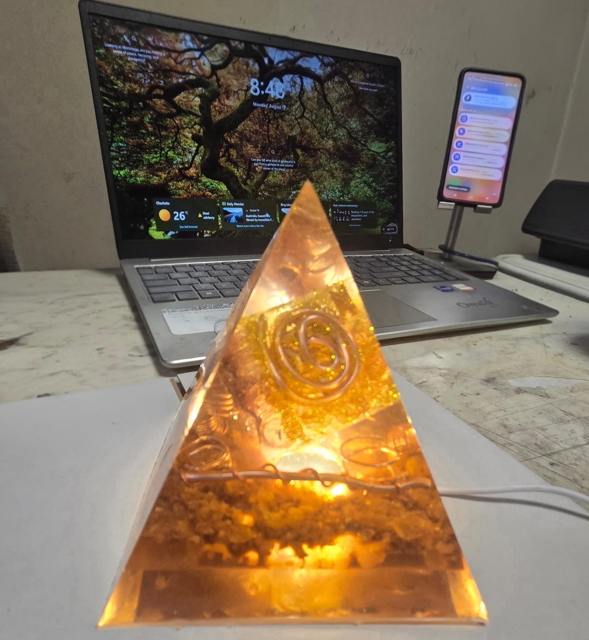 Sacred Light Orgonite Golden Amber Activation Pyramid illuminated with warm amber light