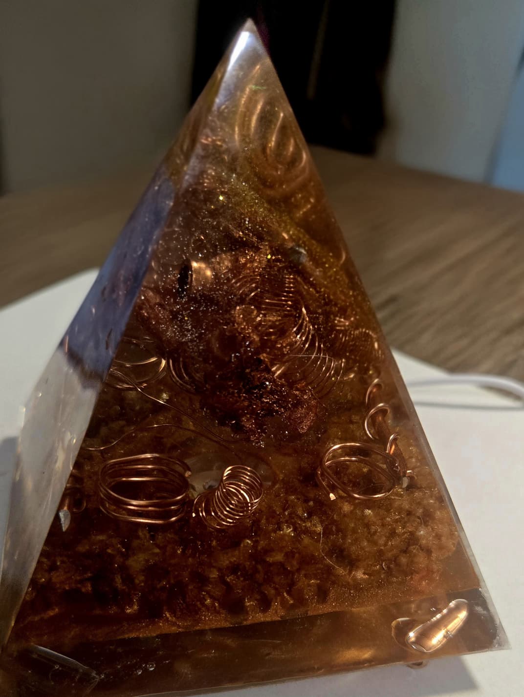 Sacred Light Orgonite Golden Amber Activation Pyramid illuminated with warm amber light