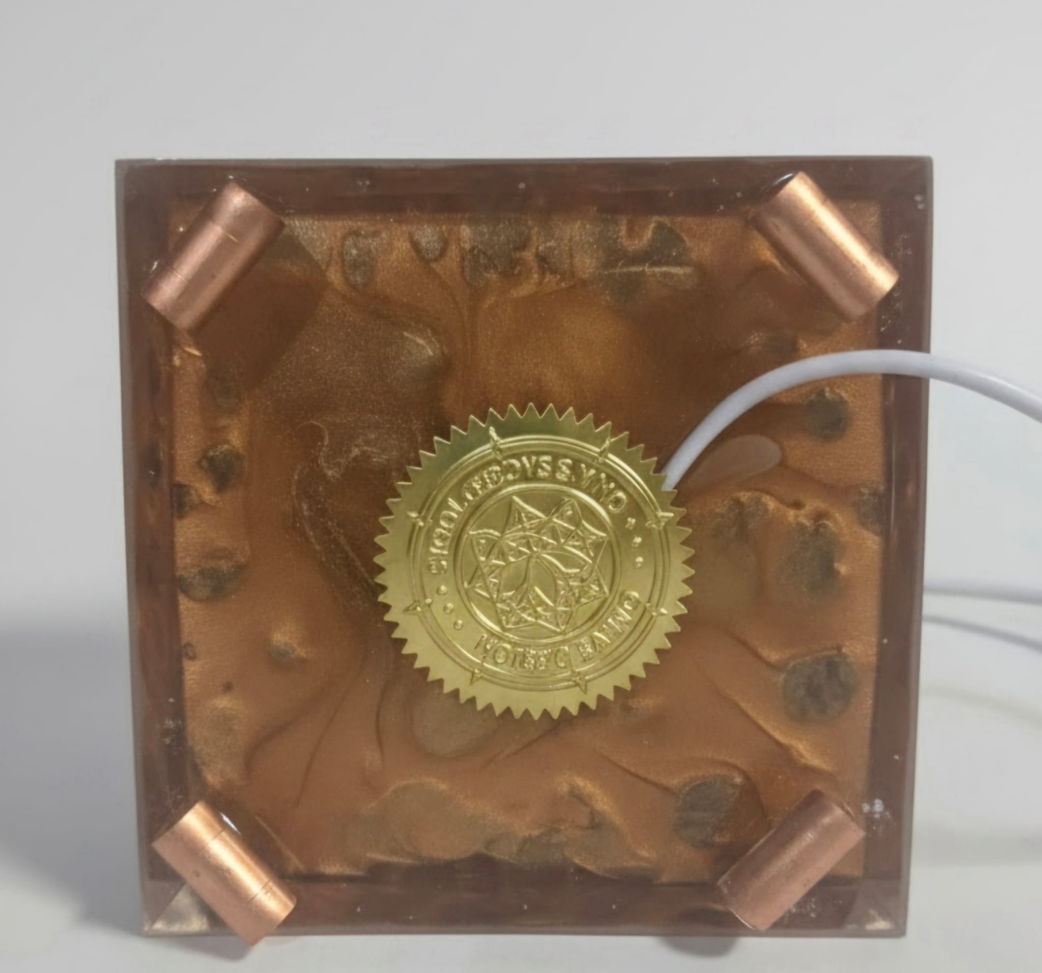 Sacred Light Orgonite Golden Amber Activation Pyramid illuminated with warm amber light
